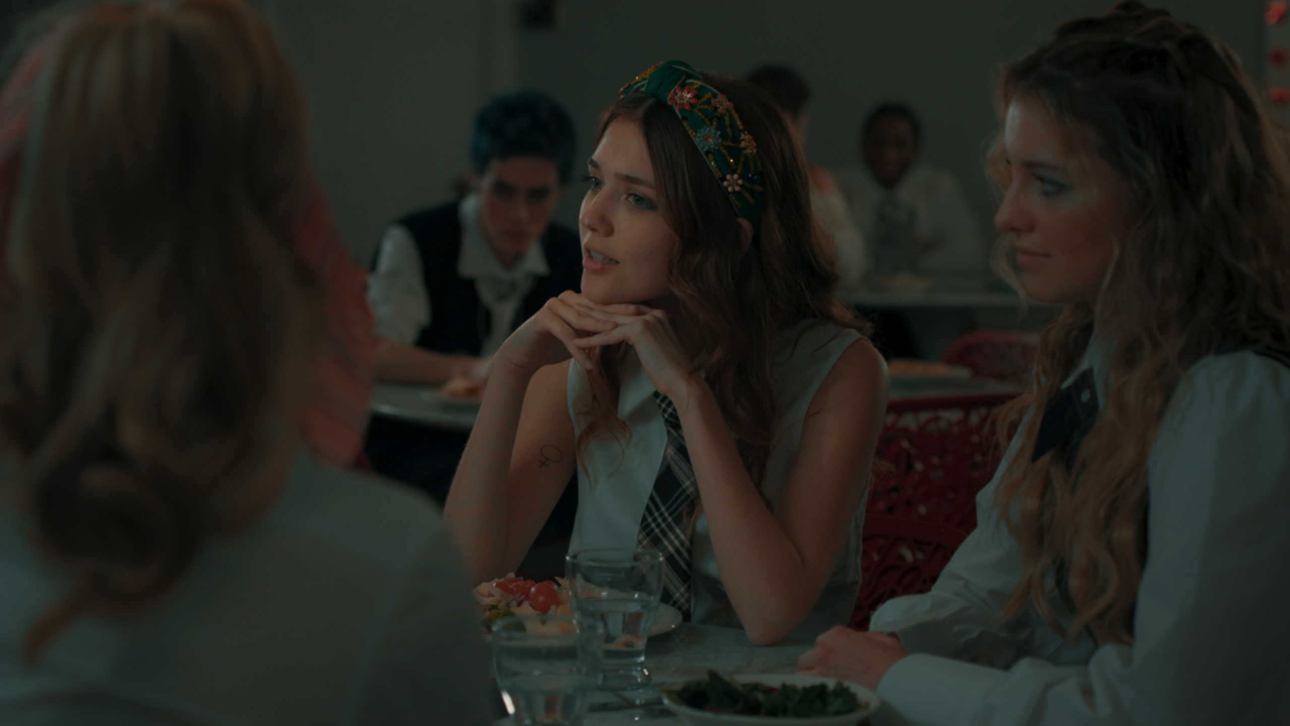 Students at cafeteria table in cool fluorescent light