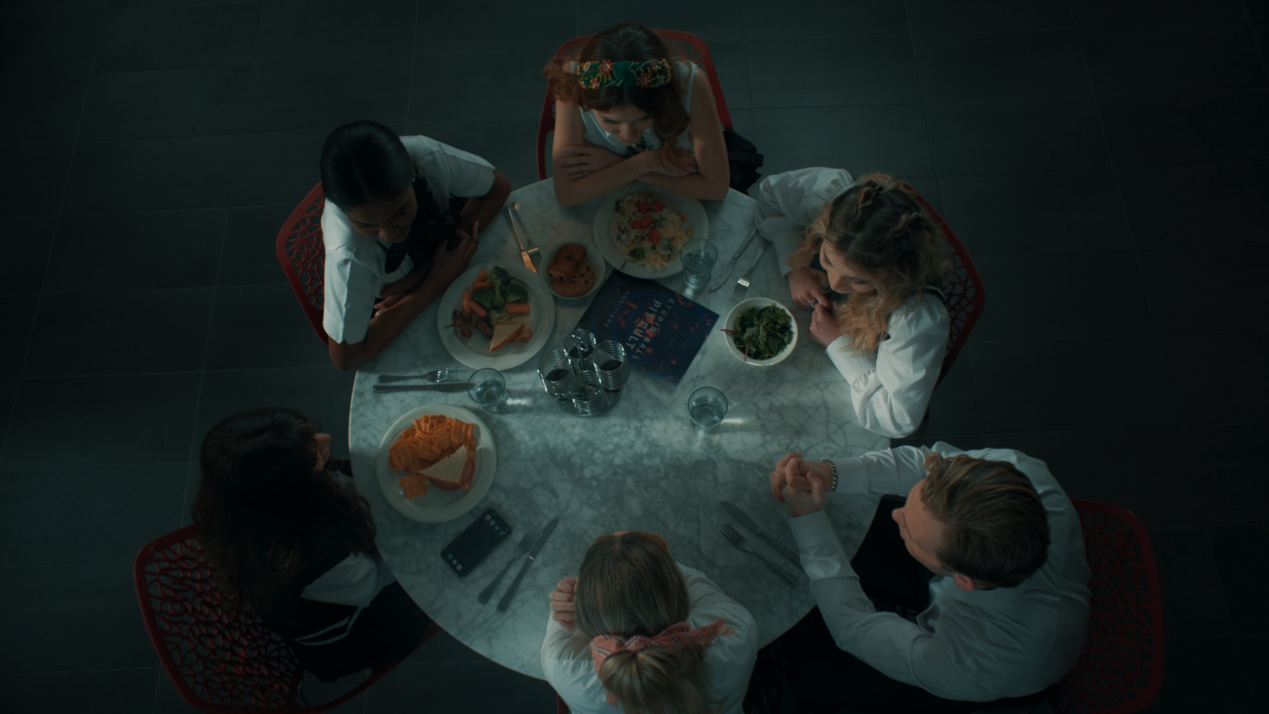 Overhead shot of students eating at round table