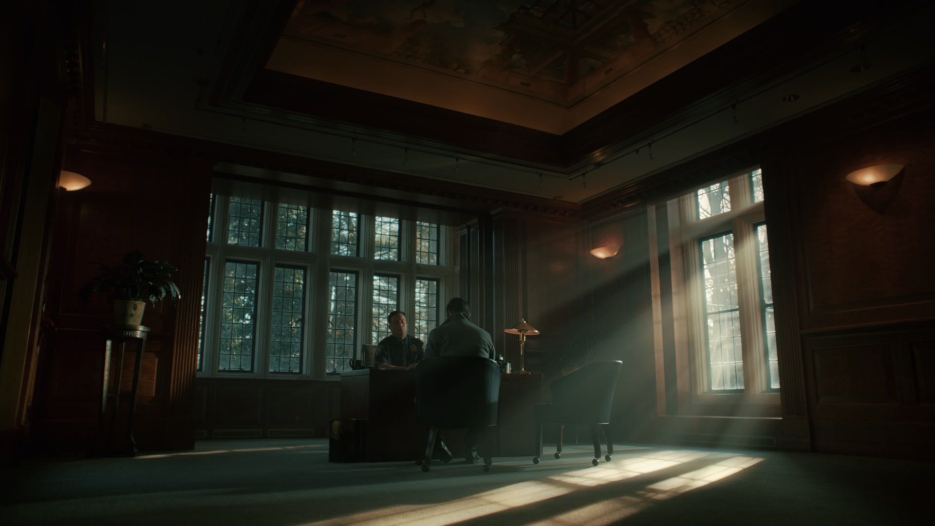 Dramatic god rays through tall windows in ornate room