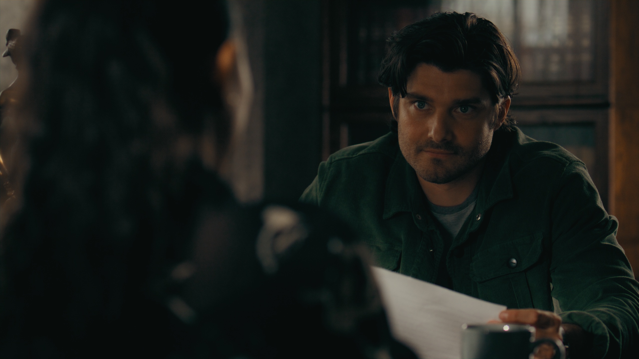 Over-the-shoulder close-up of man with papers