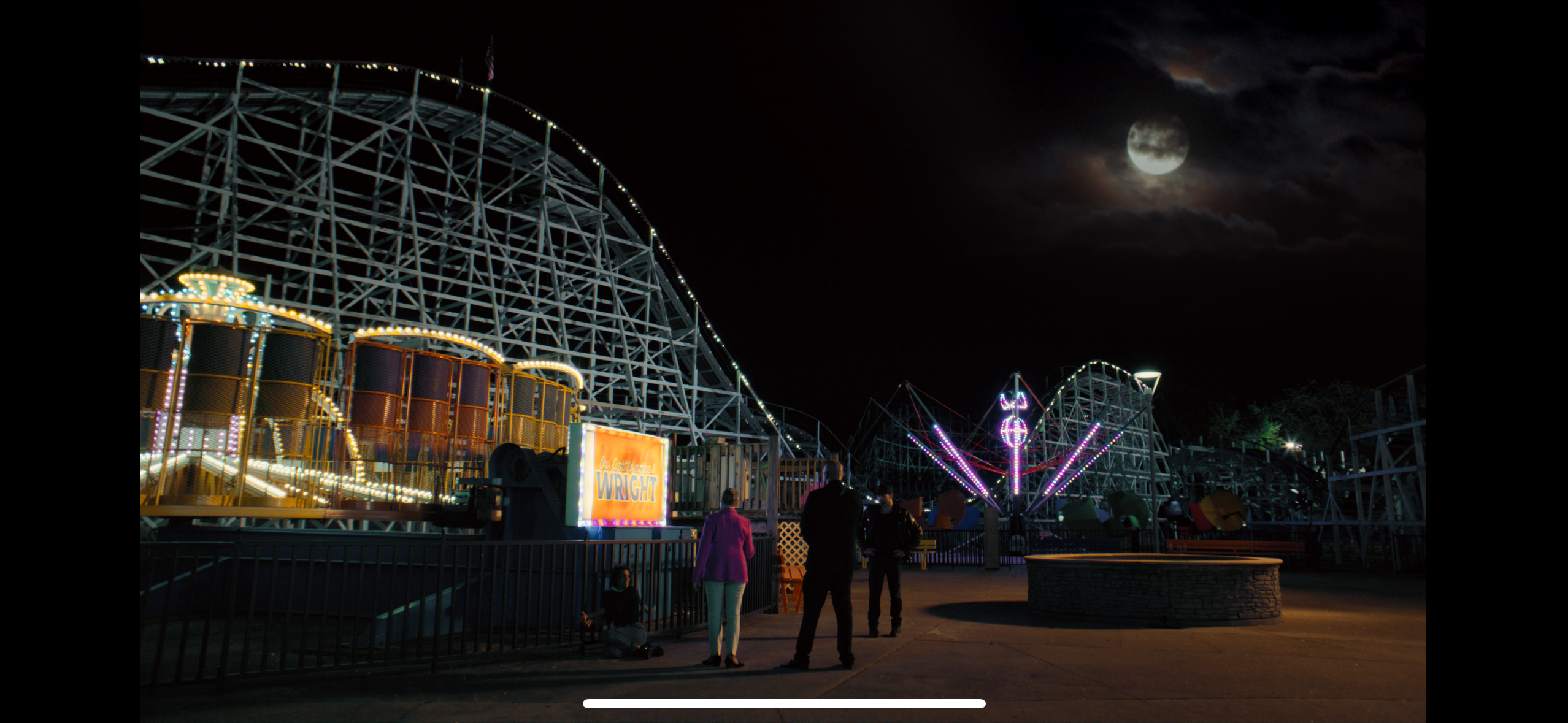 Amusement park at night with moon