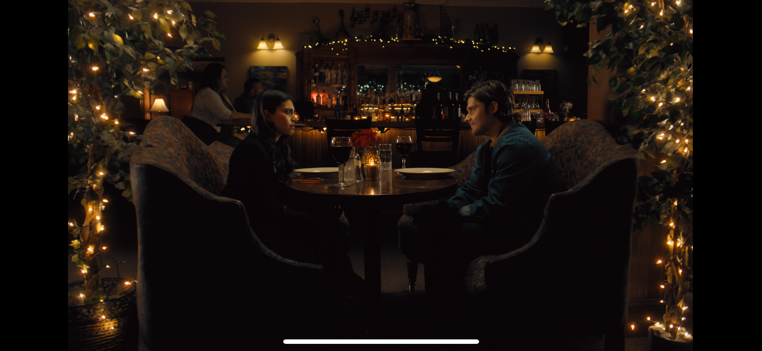 Couple at bar with Christmas lights