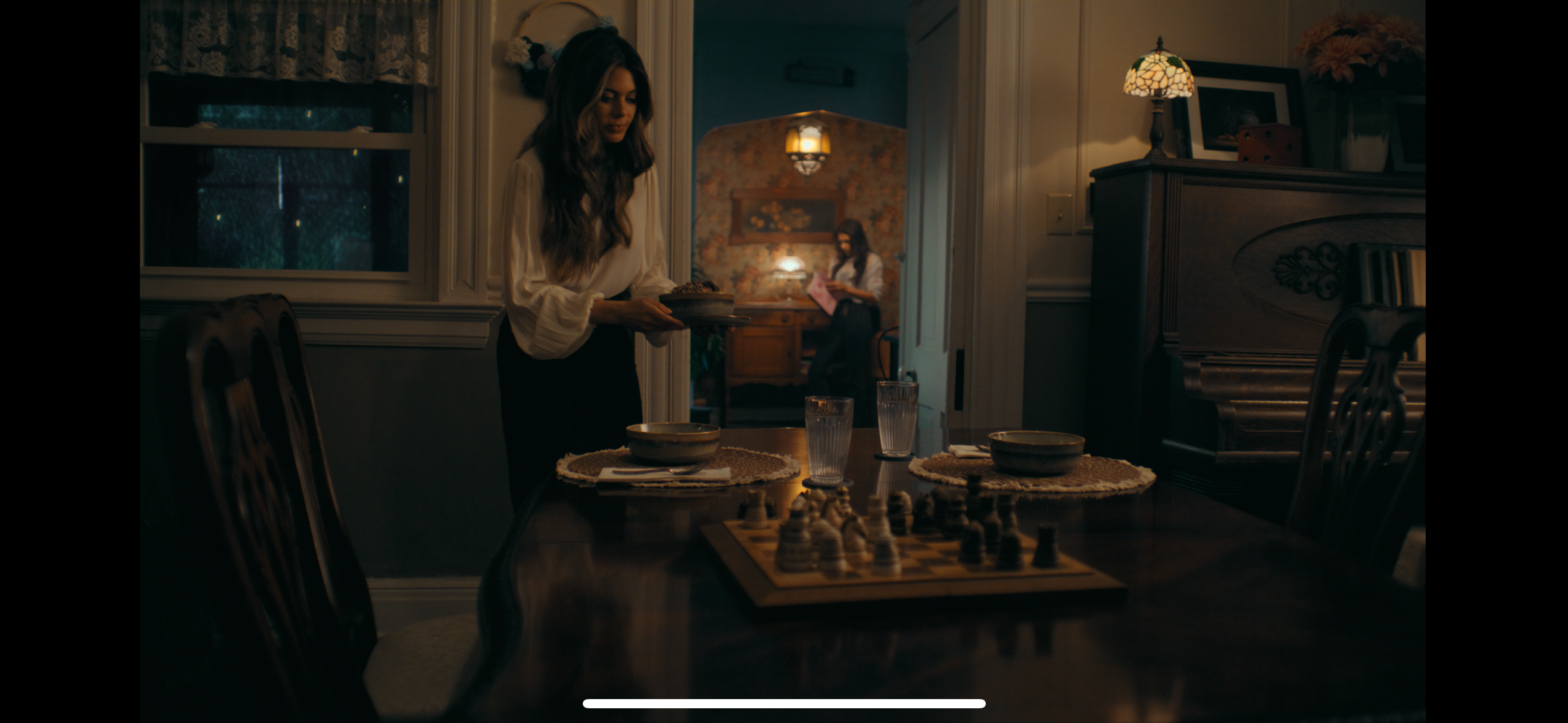 Dining room scene with candlelight and chess board