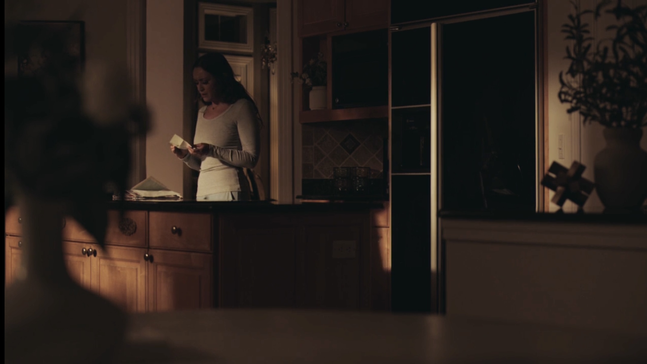 Woman reading in warm kitchen light