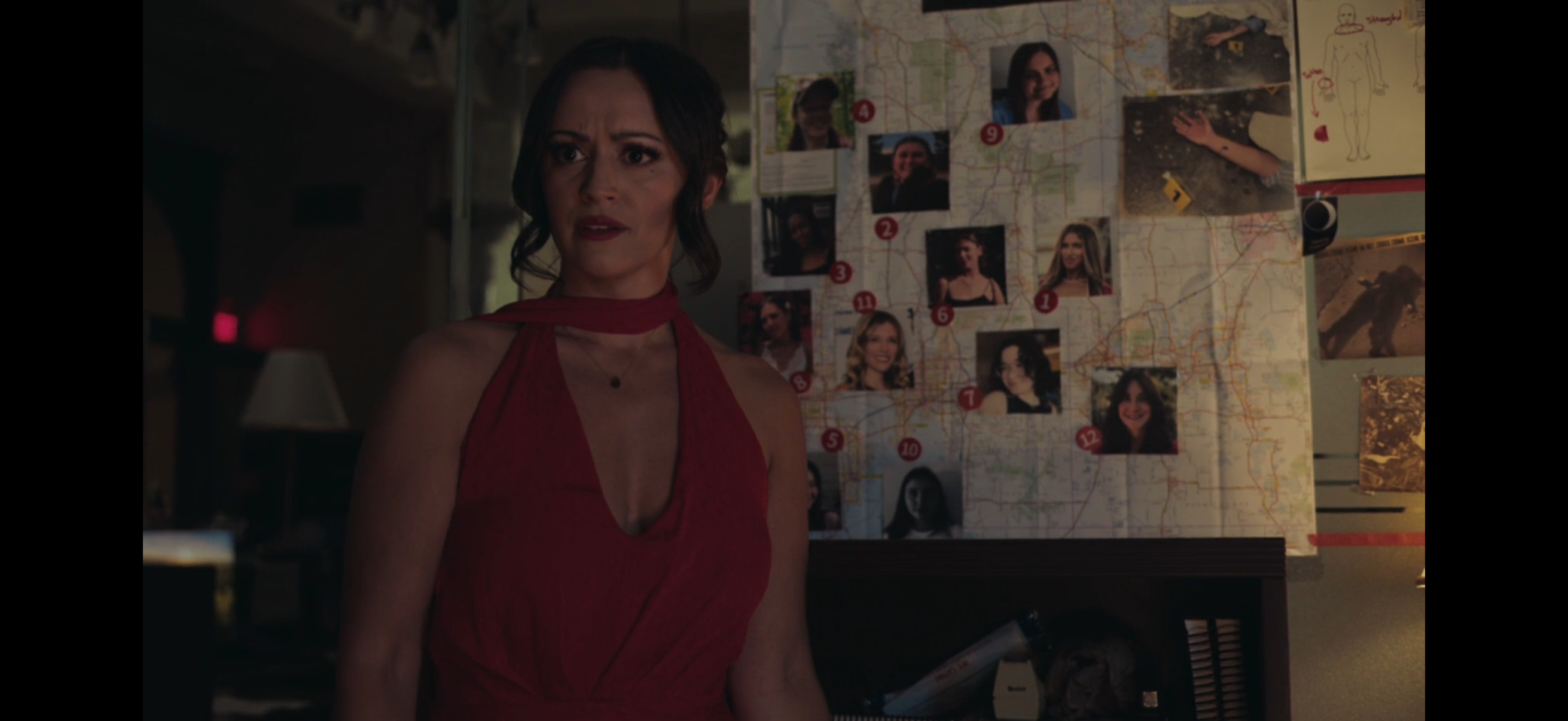 Woman in red dress with investigation board